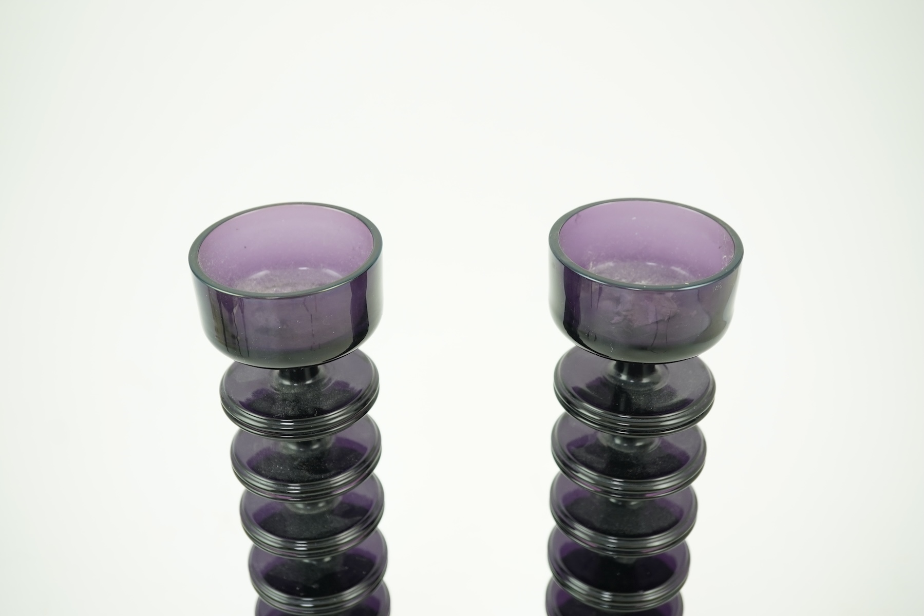 Ronald Stennett-Wilson (1915-2009) for Wedgwood: A pair of nine-ring 'Sheringham' amethyst glass candlesticks